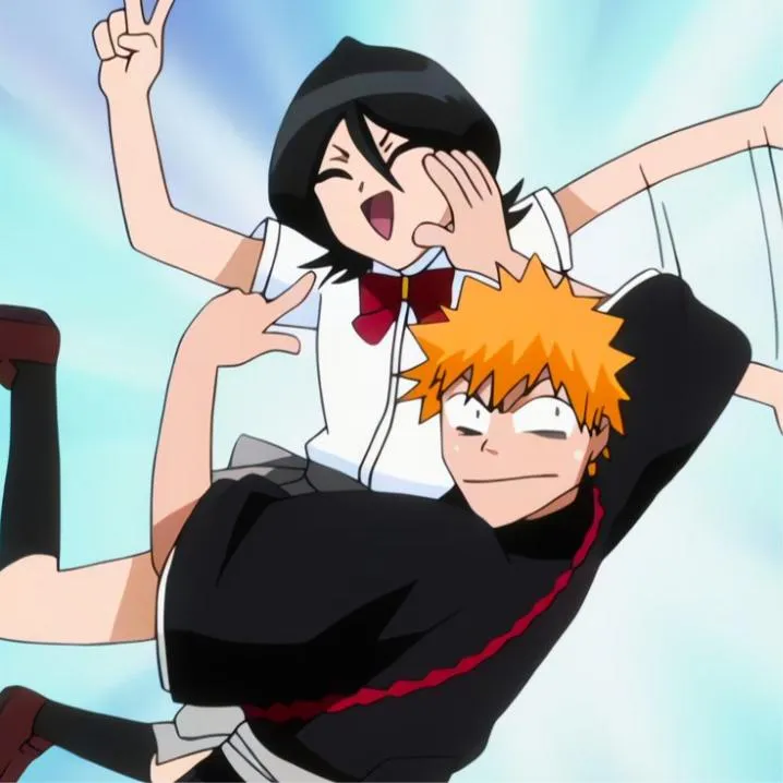 Bleach PFP #3: Rukia in a school shirt and red bow leaps with Ichigo, both making peace signs with silly faces against a pale blue sky.