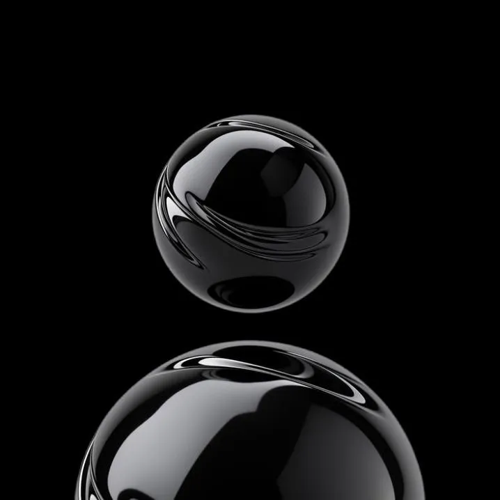Dark PFP #20: Two glossy black glass spheres, a small one stacked above a larger one, shine with white reflections against a solid black background.