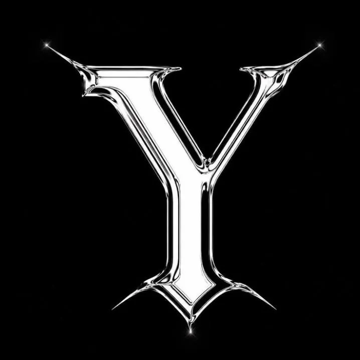 Letter PFP #140: A shiny chrome letter Y with sharp spiky tips and small sparkles stands on a plain black background.