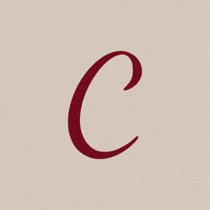 Letter PFP #90: A dark red handwritten script letter C curves across a plain warm beige background.